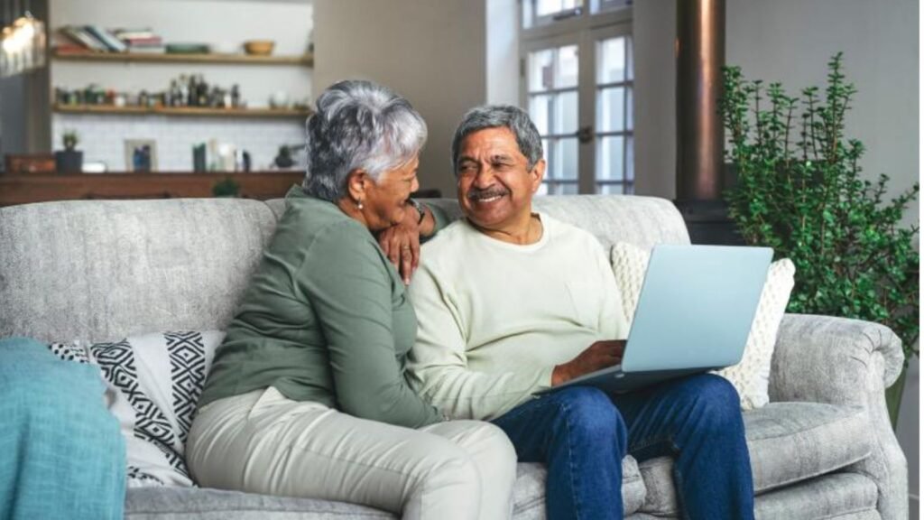 An elderly couple looking into Palliative Care Services on a laptop